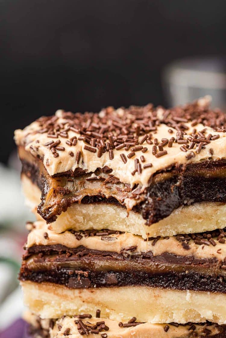 Billionaire bars stacked on top of each other with a bite missing from the top one.