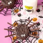 Hostess ding dong spider cakes on a pink Halloween decorated surface.