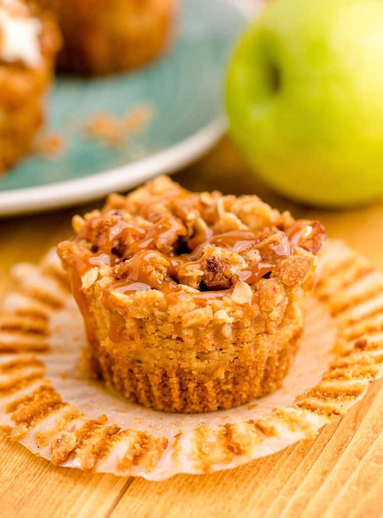 A caramel apple mini cheesecake on a wooden table.