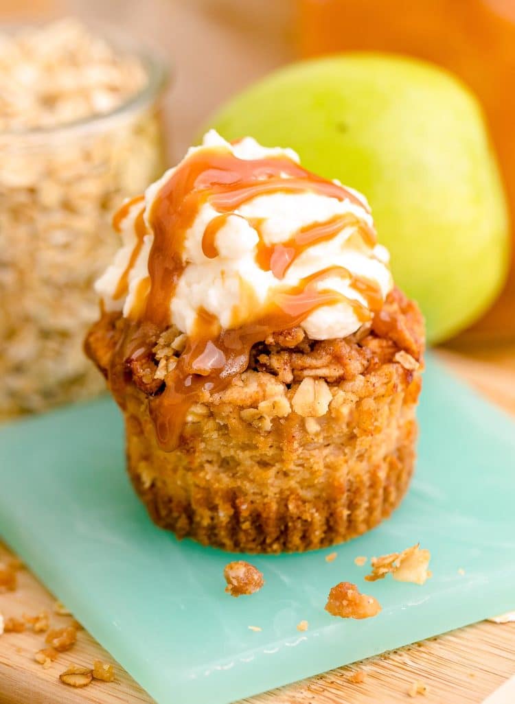 A caramel apple cheesecake on a small teal coaster.