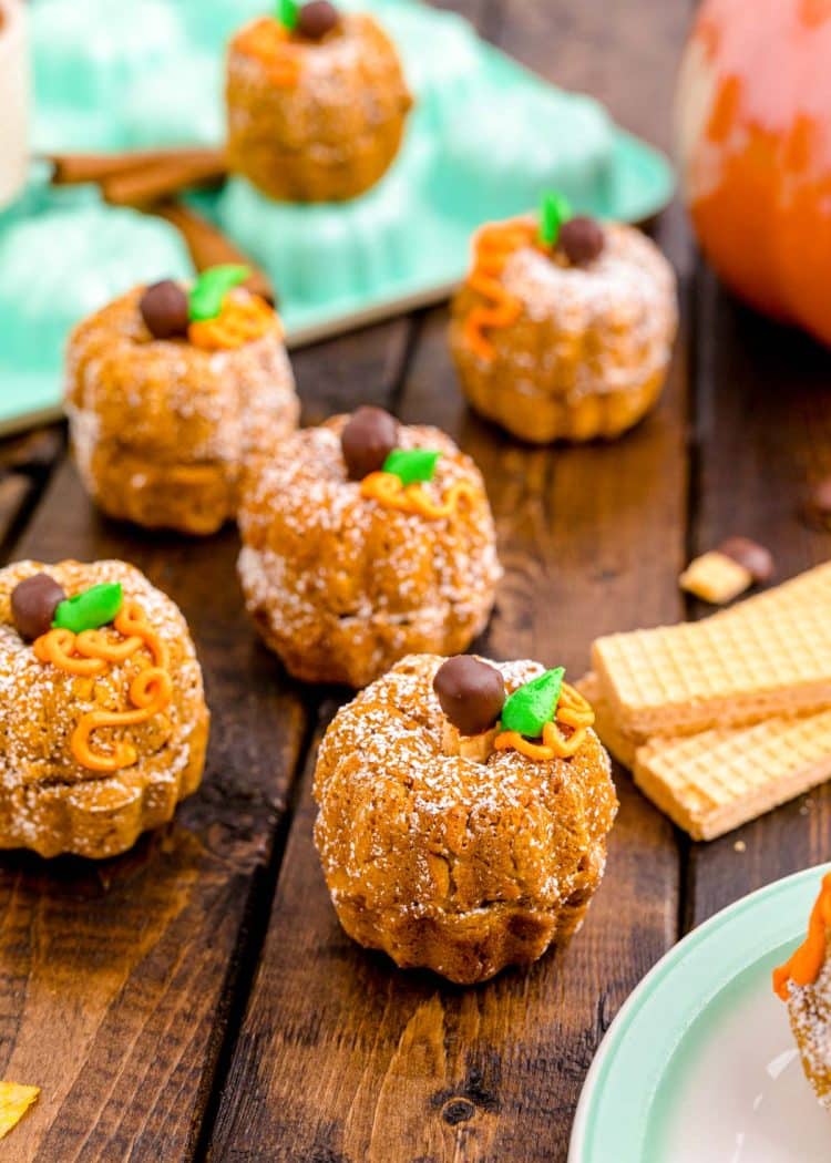 Mini pumpkin bundt cakes on a wood table.