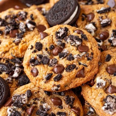 Oreo pumpkin chocolate chip cookies stacked in a pile.