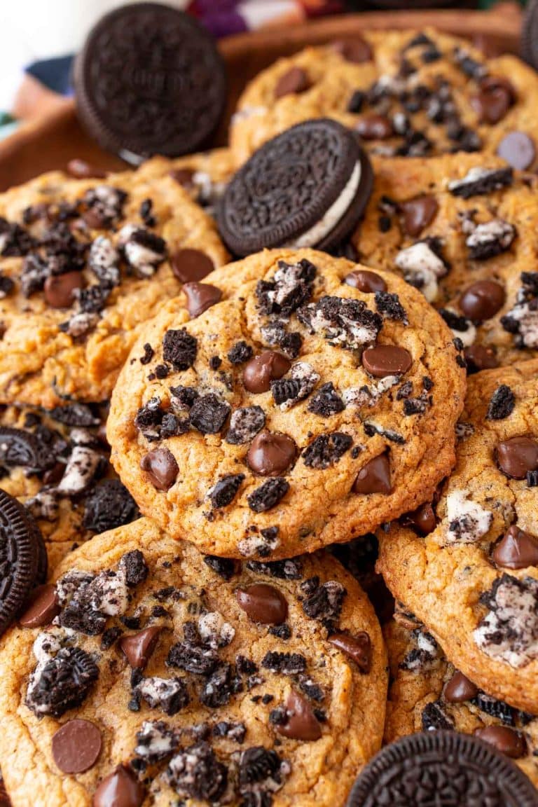 Oreo pumpkin chocolate chip cookies stacked in a pile.