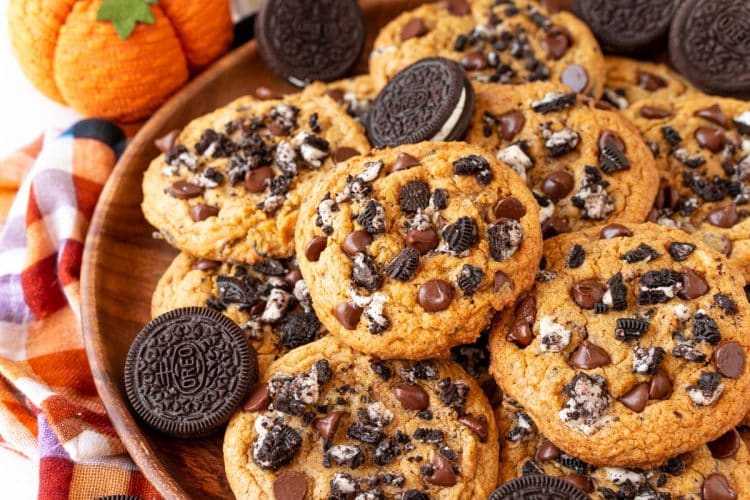 Oreo pumpkin chocolate chip cookies stacked in a pile.