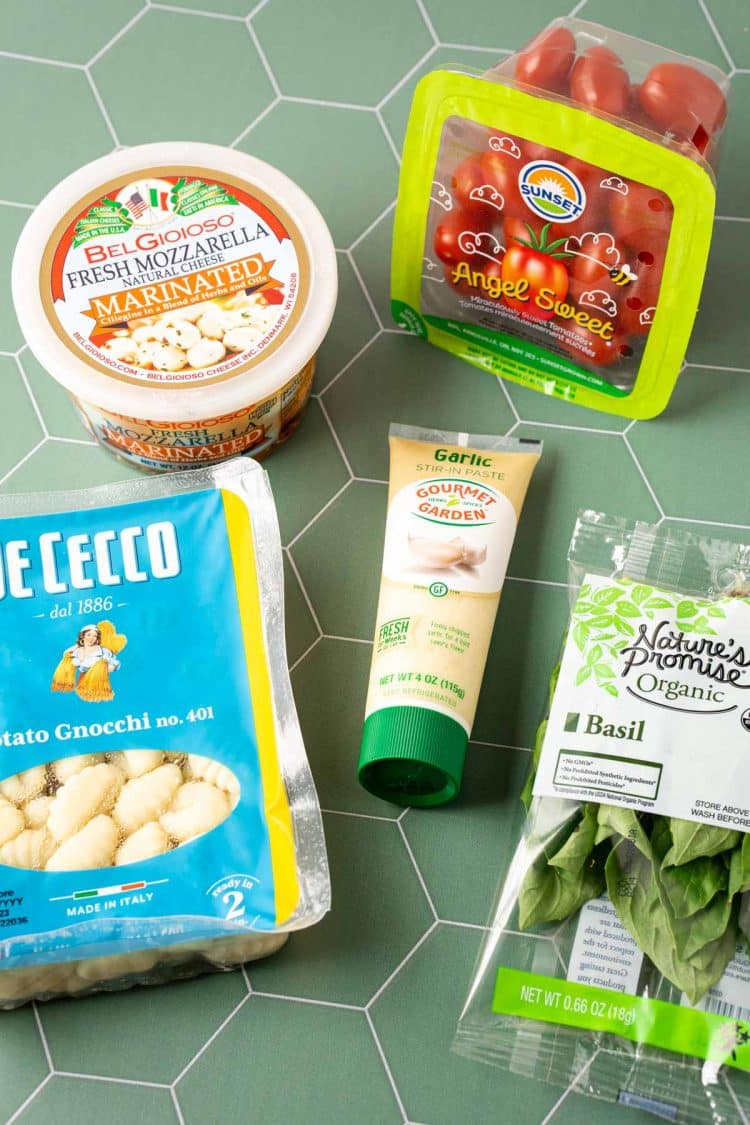 Ingredients to make TikTok baked gnocchi on a green surface.