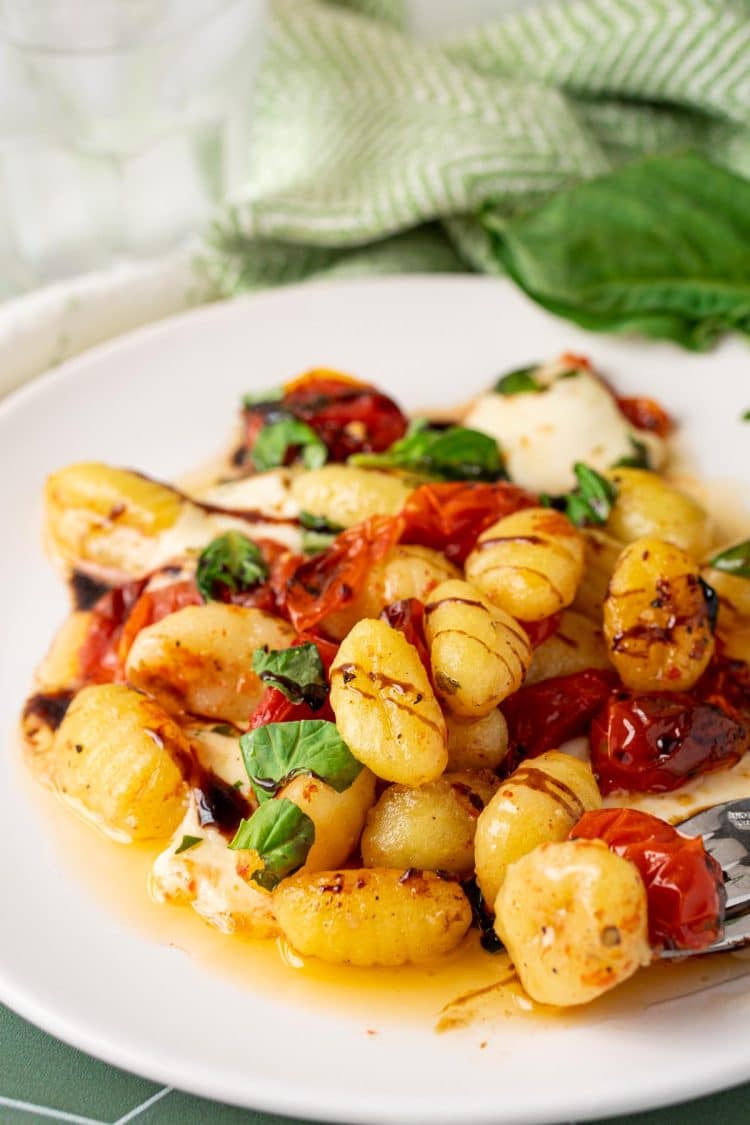 Baked Caprese Gnocchi on a white plate.