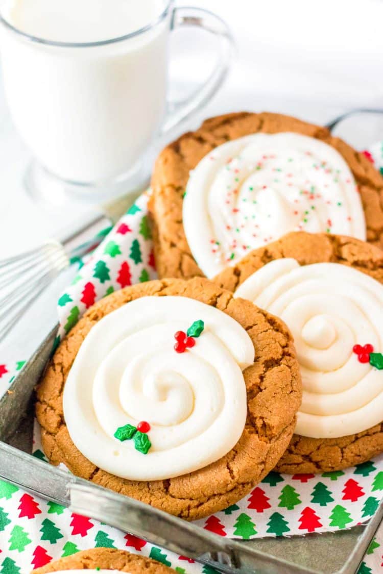 Giant gingerbread cookies with cream cheese frosting in a tin tray.