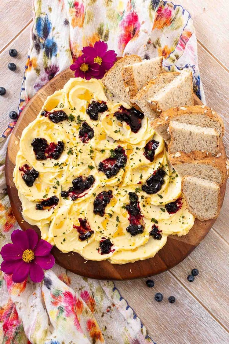 Overhead photo of a butter board on a floral napkin.