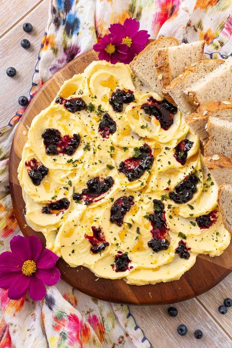 Overhead photo of a butter board on a floral napkin.