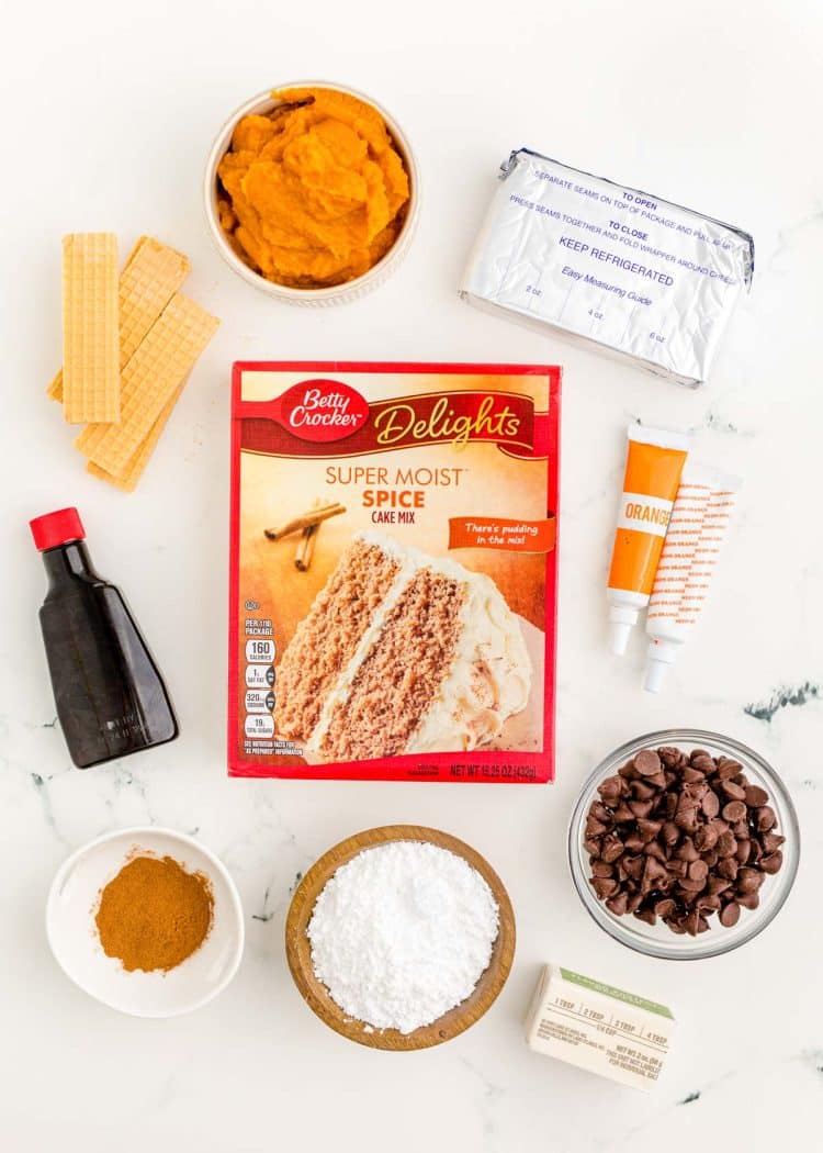 Ingredients to make mini pumpkin bundt cakes on a white marble surface.