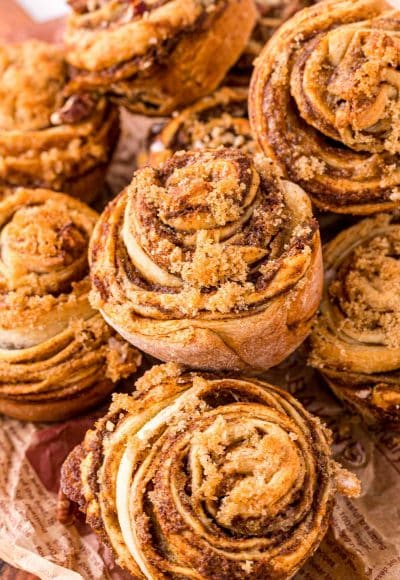 Pumpkin Cinnamon Roll Muffins piled on top of each other.