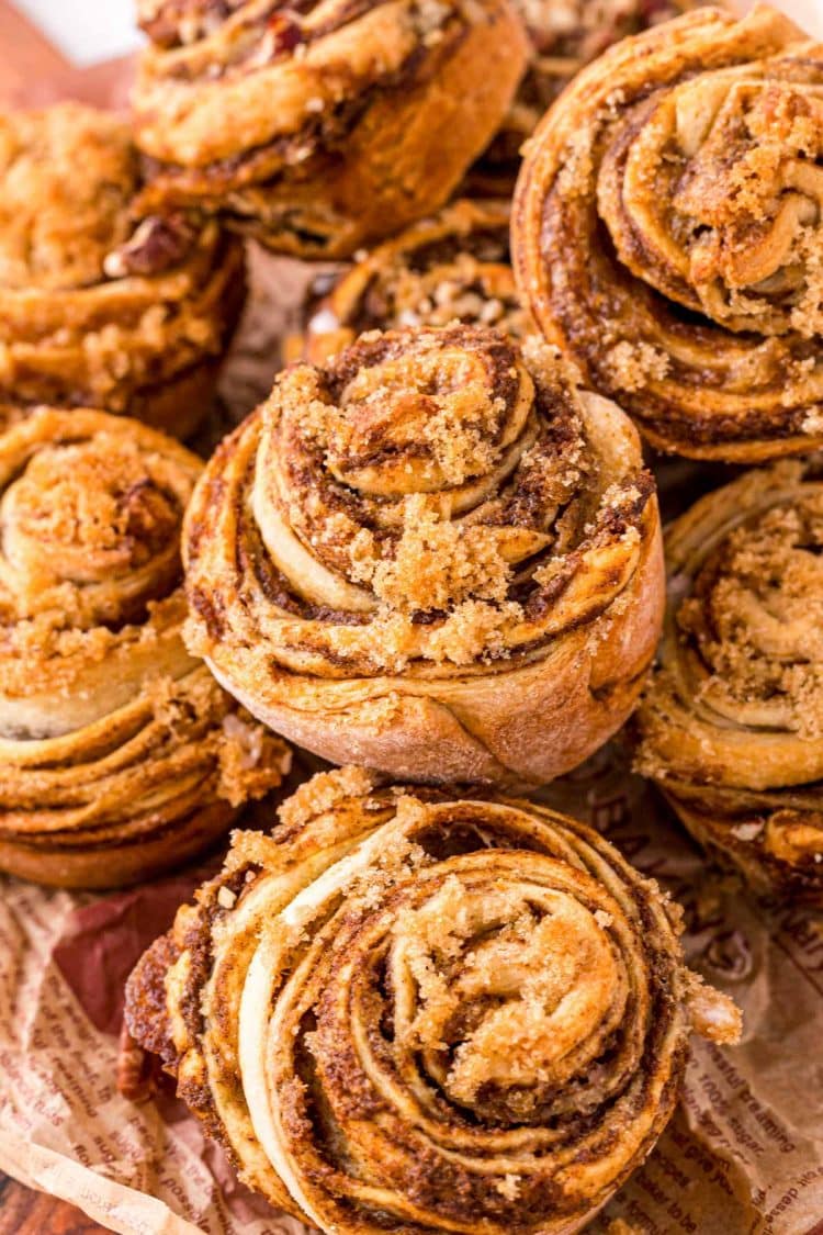 Pumpkin Cinnamon Roll Muffins piled on top of each other.
