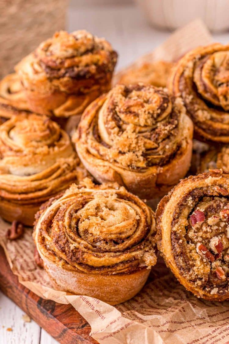 Pumpkin Cinnamon Roll Muffins piled on top of each other.