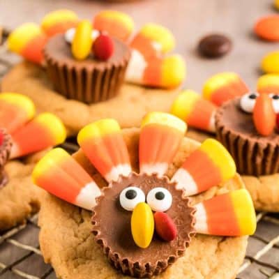 Close up photo of peanut butter cookies decorated as turkeys with candy.