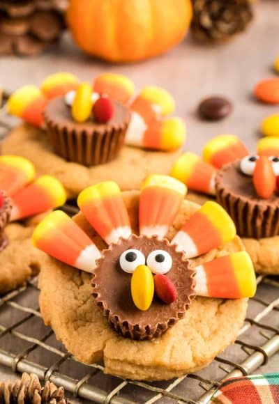 Close up photo of peanut butter cookies decorated as turkeys with candy.