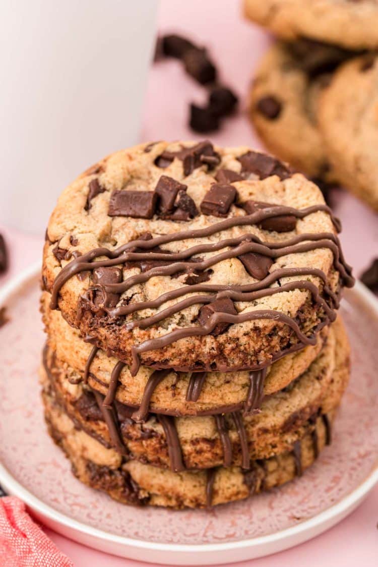 Brown butter chocolate chip cookies stacked on a plate.