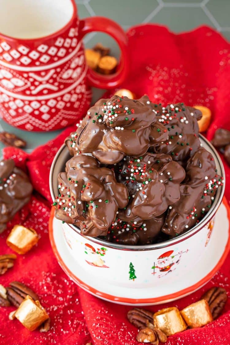 Crockpot turtle candy in a holiday bowl on a red napkin.