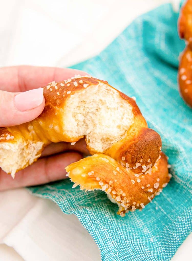 A soft pretzel ripped open showing the inside texture.