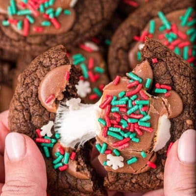 A woman's hand pulling a hot chocolate cookie apart.