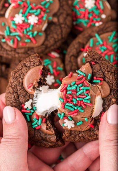 A woman's hand pulling a hot chocolate cookie apart.