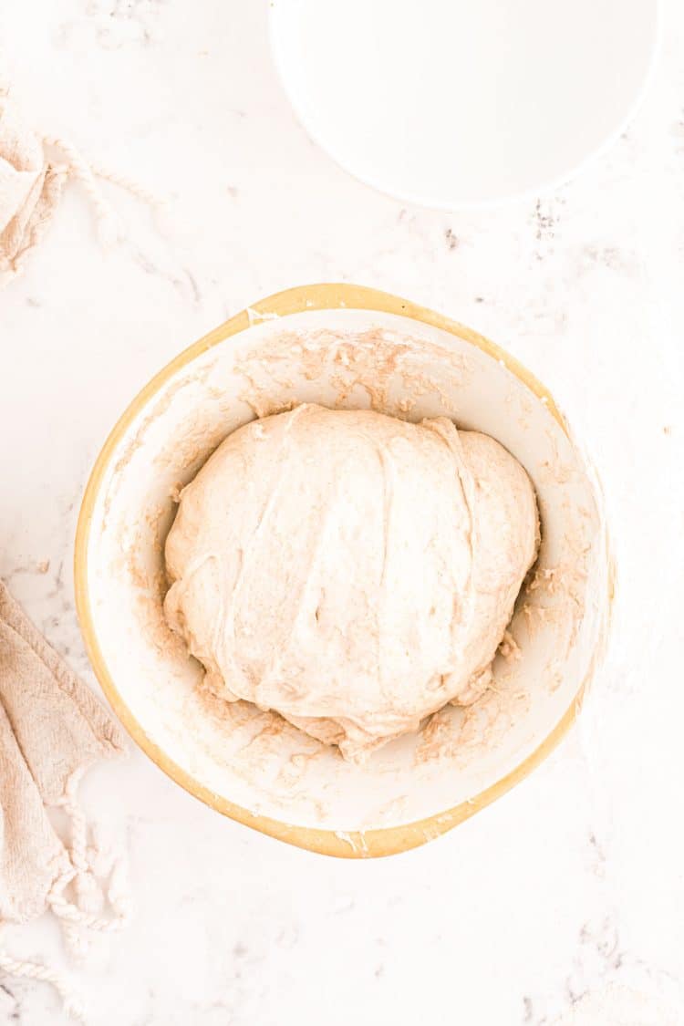 Sourdough dough that has gone through its first kneading and is resting in the bowl.