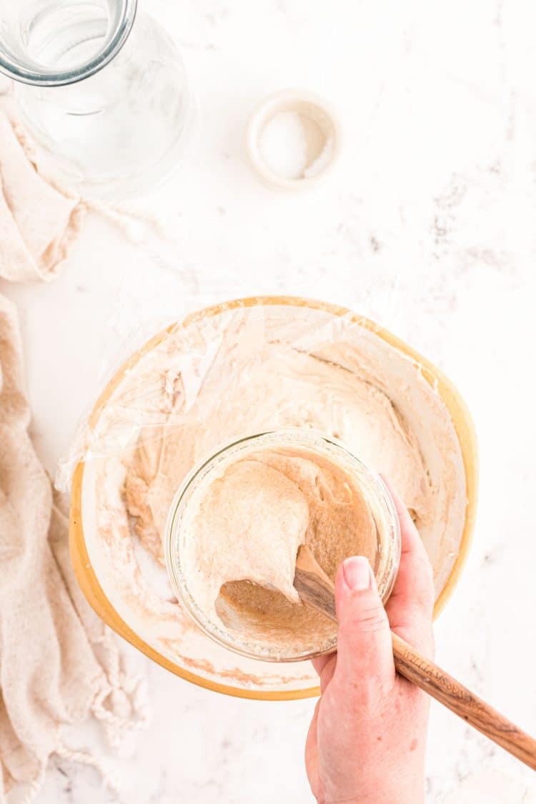 Sourdough being adding to autolysed dough to make sourdough bread.