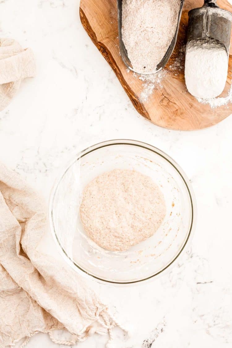 Overhead photo of a sourdough starter in a glass bowl.