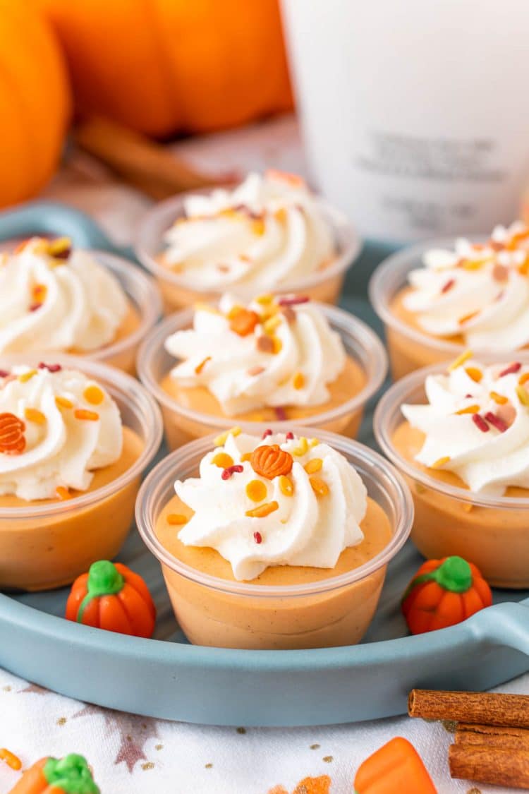 Pumpkin pudding shots on a blue plate.