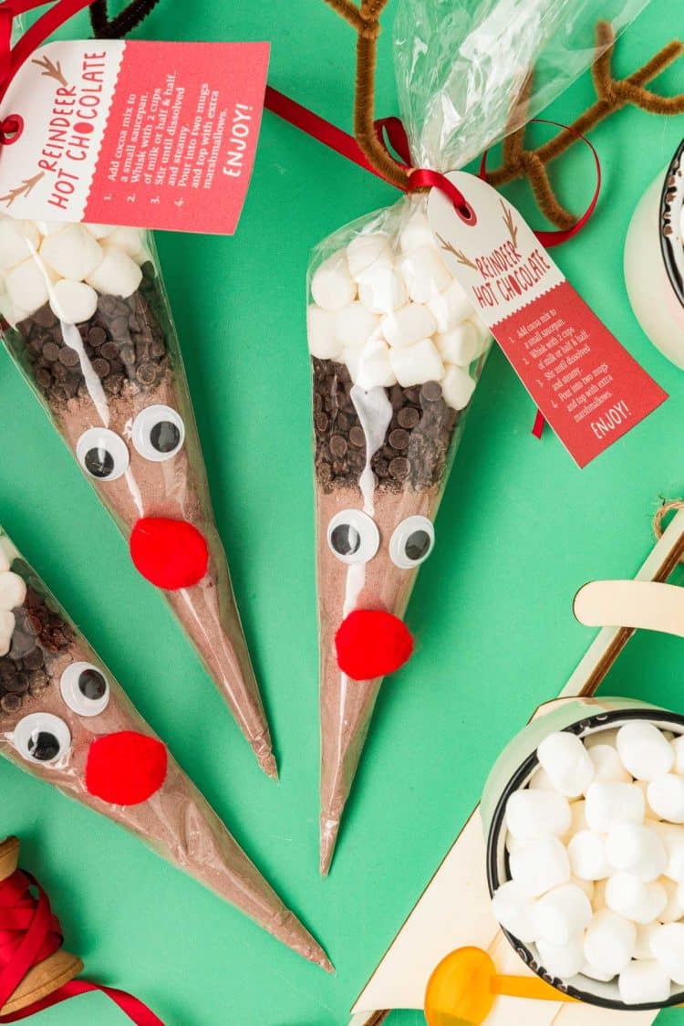 Reindeer hot chocolate cones on a green surface.