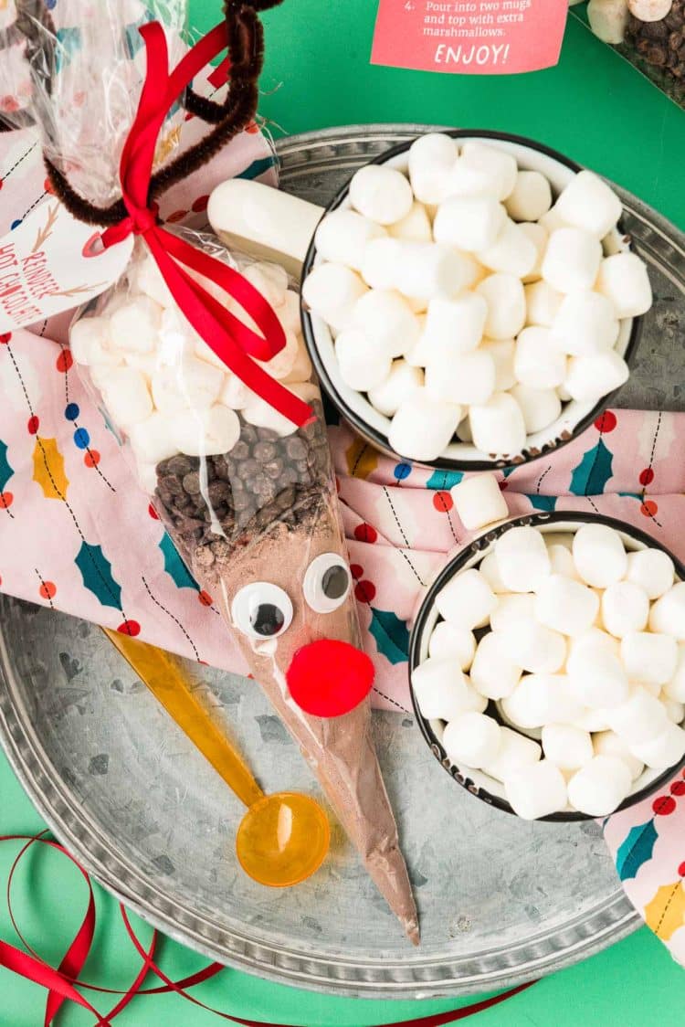 Reindeer hot chocolate cone on a tray with mugs of hot chocolate.