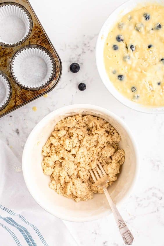 Ingredients to make streusel in a bowl being mixed.