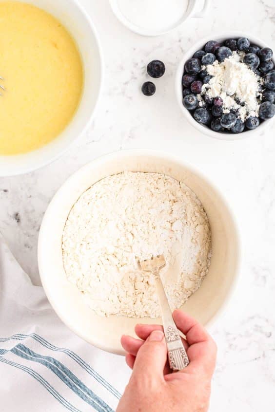 Dry ingredients being mixed with a fork in a bowl.