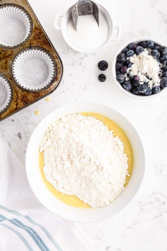 Overhead photo of a mixing bowl with dry ingredients being added to wet.