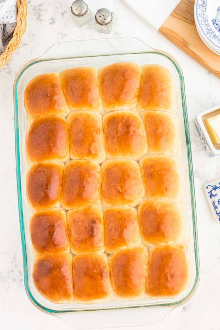 Overhead photo of sourdough dinner rolls in a glass pan.