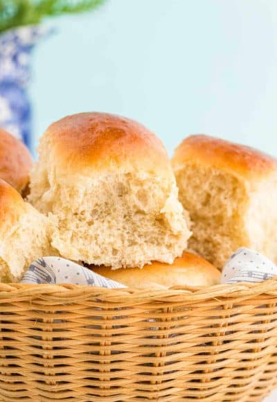 Close up photo of sourdough discard dinner rolls in a basket.