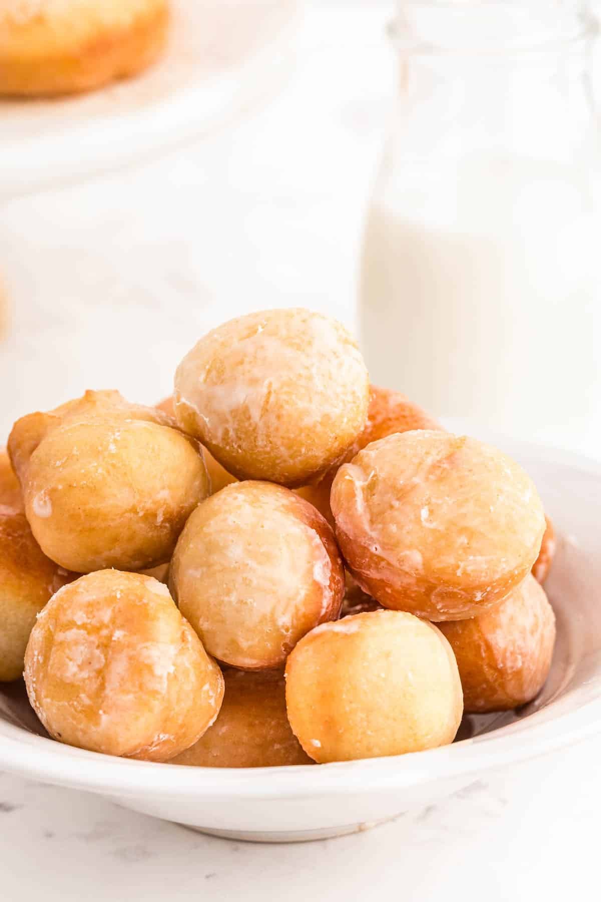 Sourdough donut holes in a white bowl.