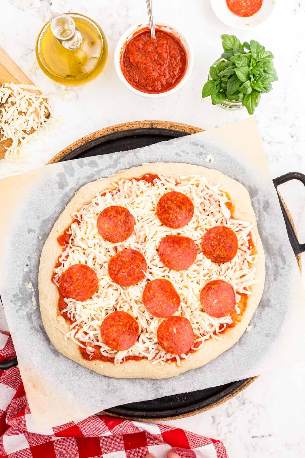 Sourdough pizza with toppings on it ready to be baked.