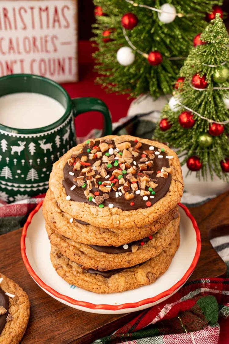 A stack of four Christmas Crack Cookies on a holiday plate.