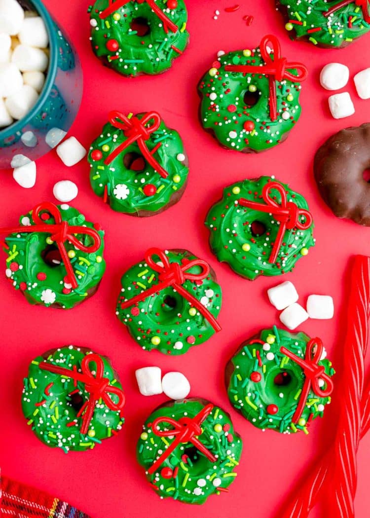 Overhead photo of Christmas Wreath Cookies on a red surface.