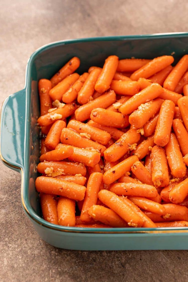 Carrots in a baking dish ready to roast.