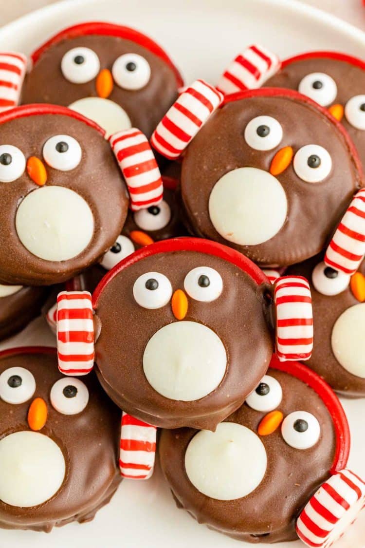 Close up photo of Oreo Penguin Cookies piled on a white plate.