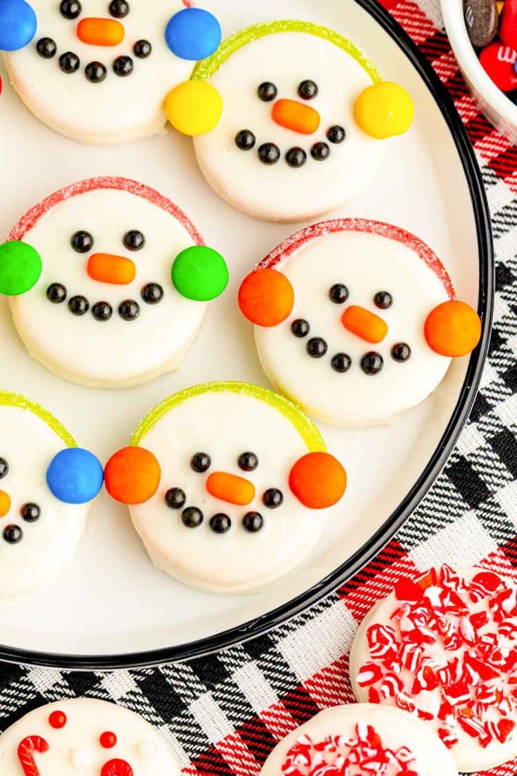 A close up of Oreo Snowman Cookies on a white plate.