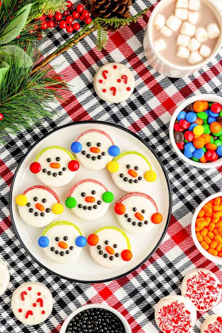 Overhead photo of white chocolate dipped Oreos decorated like snowmen.