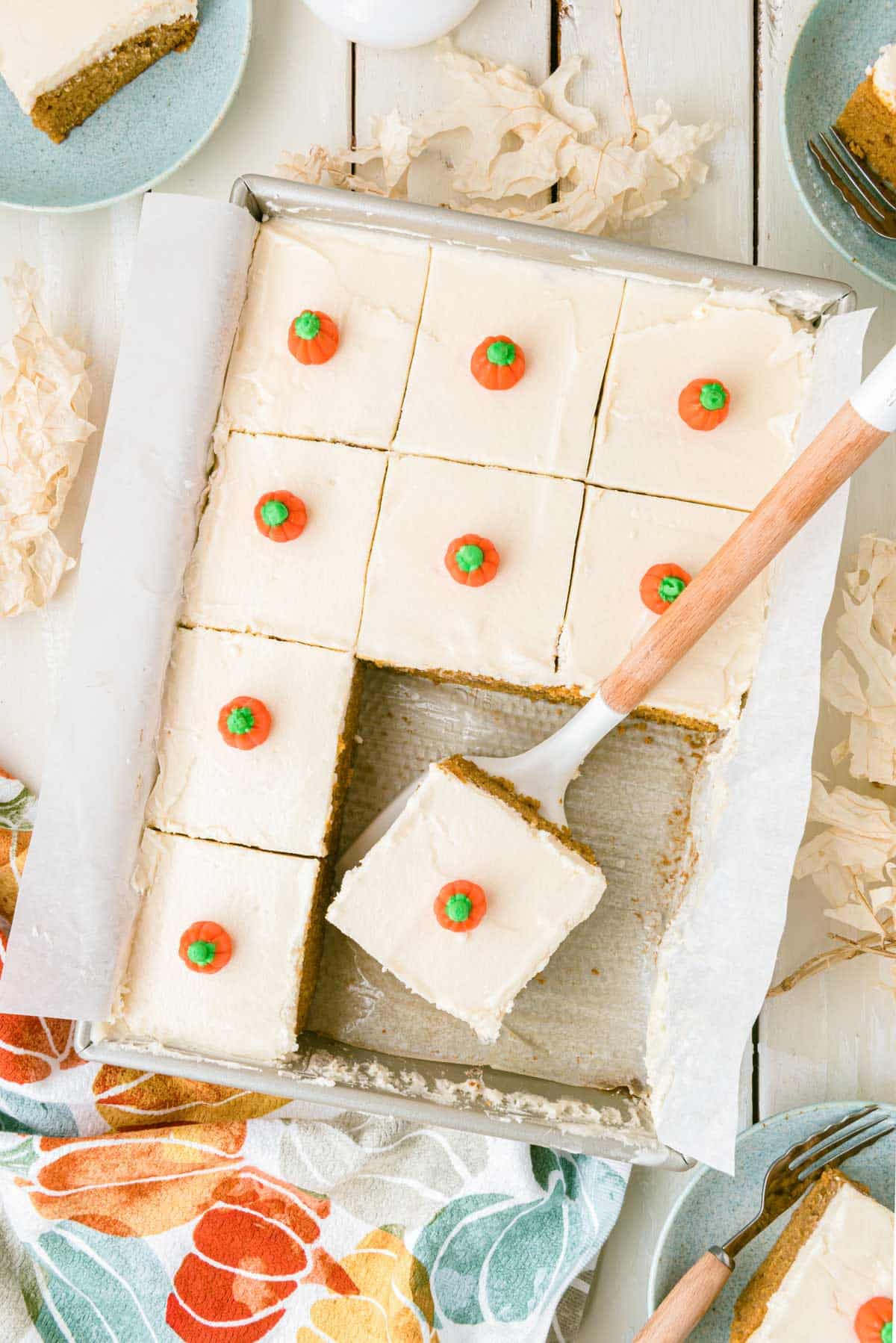 Overhead photo of sliced pumpkin cake in a 9x13-inch pan.