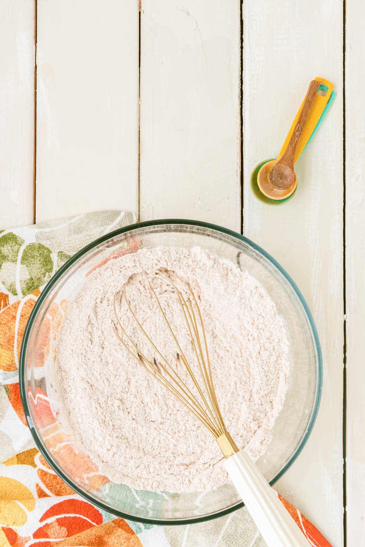 Dry ingredients for pumpkin cake being whisked in a bowl.