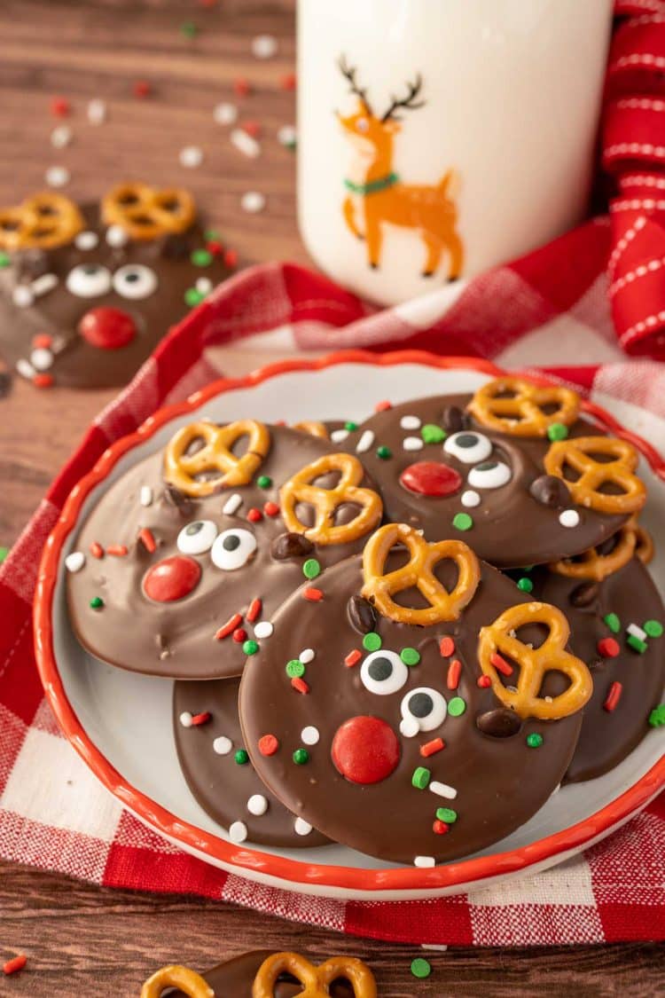 A small plate with Reindeer Christmas Bark on it with a bottle of milk in the background.