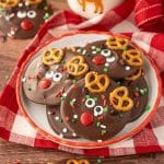 A small plate with Reindeer Christmas Bark on it with a bottle of milk in the background.