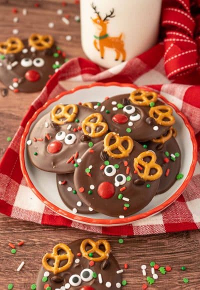 A small plate with Reindeer Christmas Bark on it with a bottle of milk in the background.