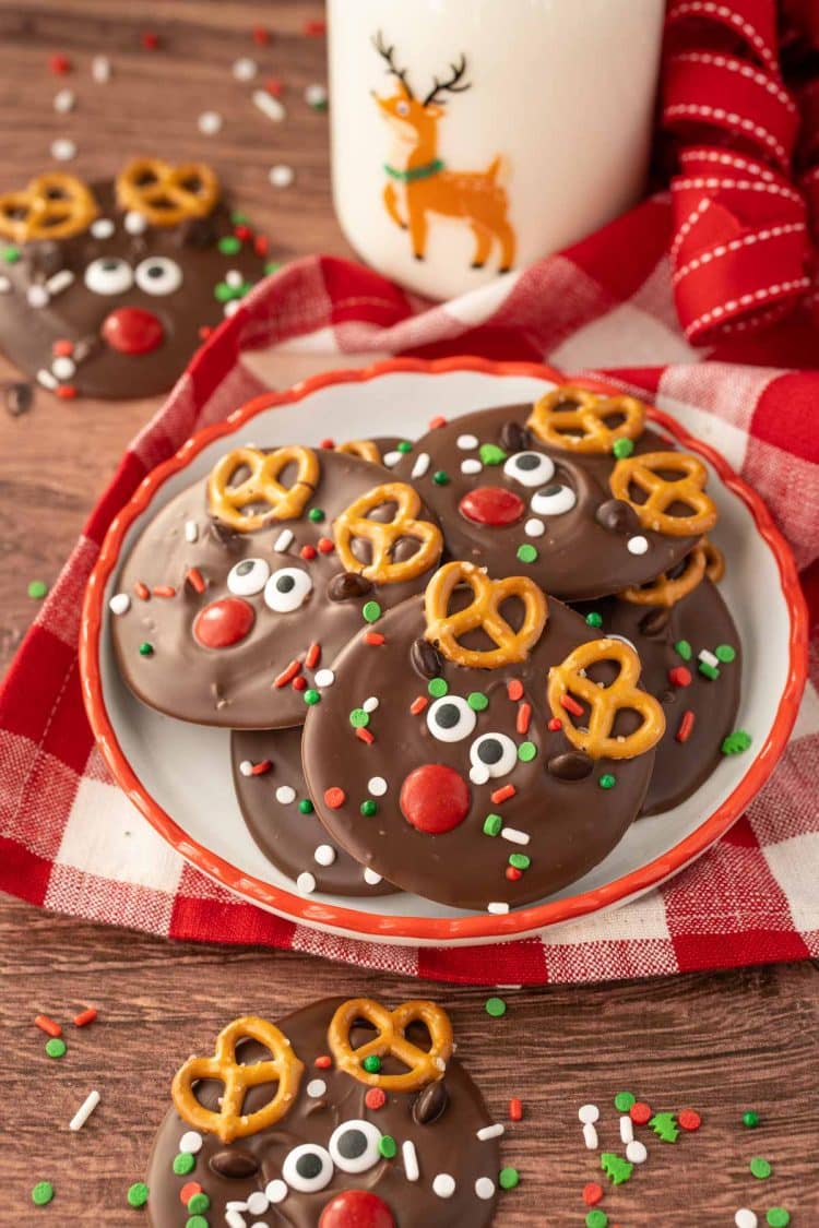 A small plate with Reindeer Christmas Bark on it with a bottle of milk in the background.