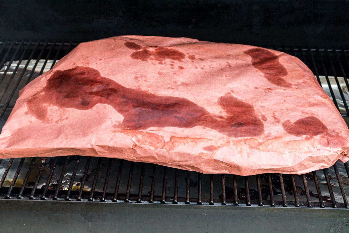 brisket in butcher paper in smoker